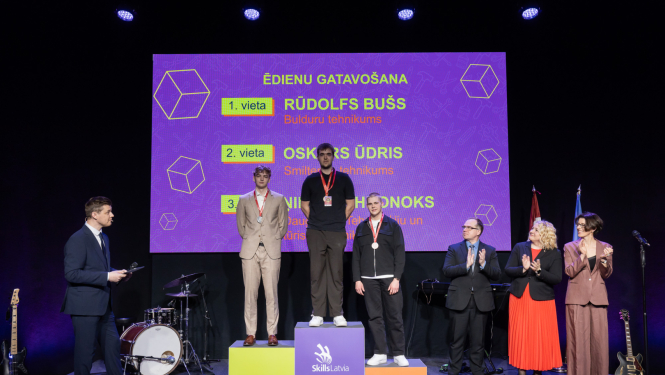 SkillsLatvia konkursa “Ēdienu gatavošana” laureāti apbalvošanas ceremonijā uz goda pjedestāla.