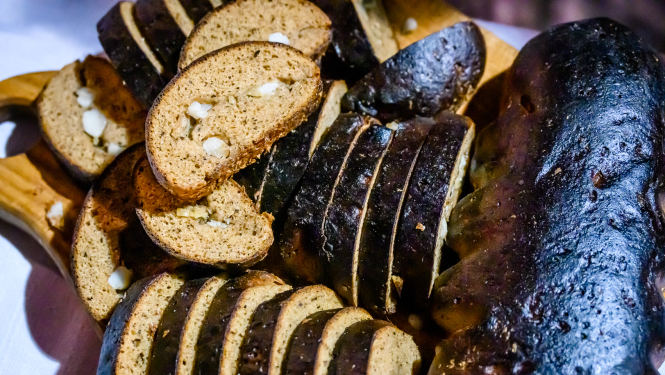 Rudzu maizes klaips, kurā ievīstīts žāvēts speķis un sīpoli